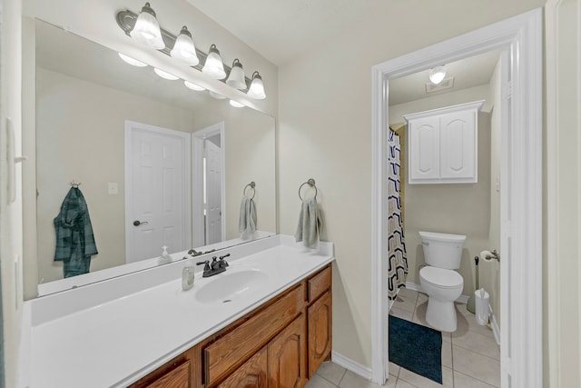 bathroom with tile patterned floors, vanity, and toilet