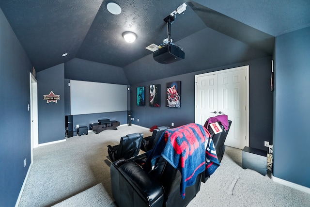 carpeted cinema room featuring a textured ceiling and lofted ceiling