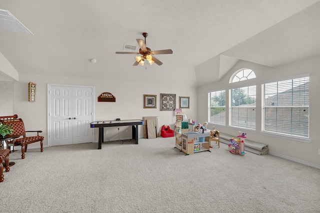 playroom featuring carpet, ceiling fan, and vaulted ceiling