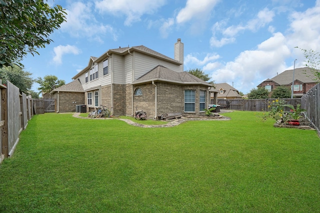 back of property featuring a lawn and central AC