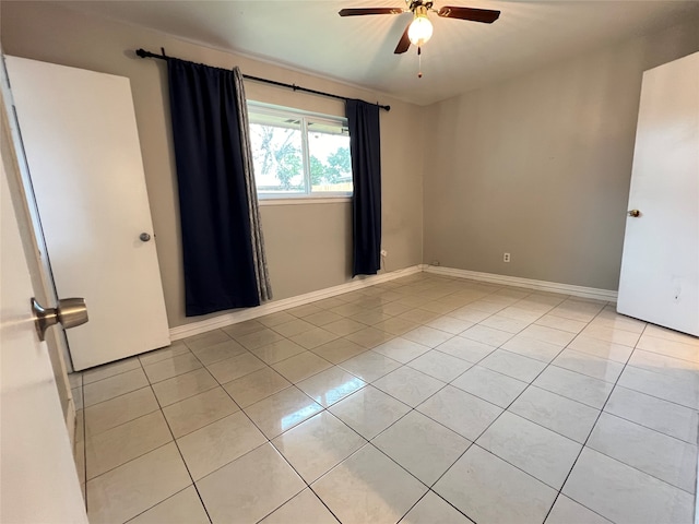 tiled empty room with ceiling fan