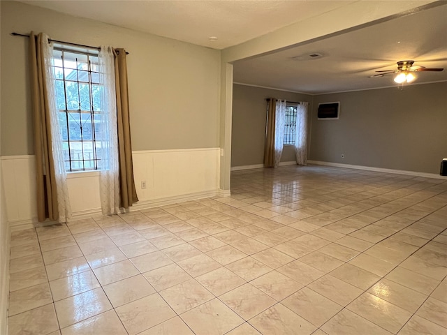 tiled empty room with ceiling fan