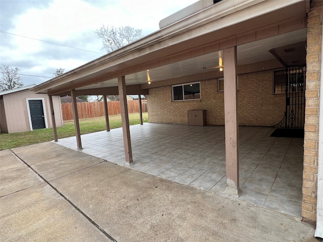 view of patio featuring a storage shed and a carport