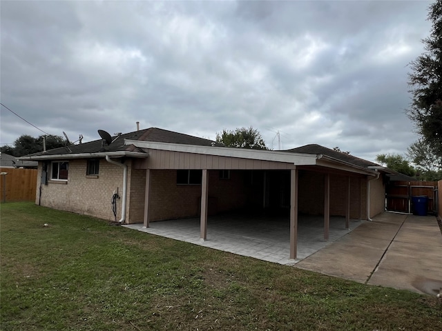 rear view of house featuring a yard