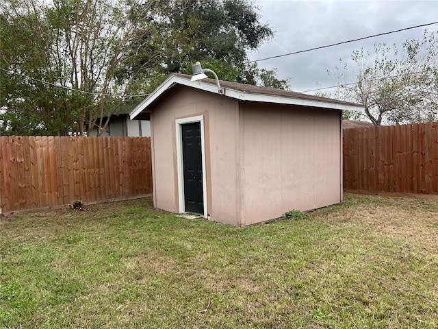 view of outbuilding with a lawn