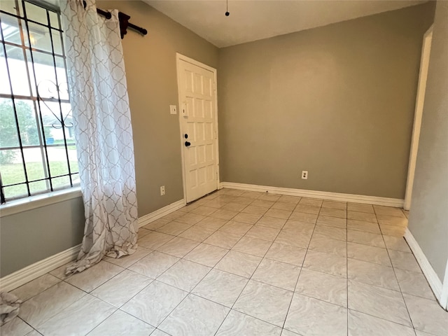 foyer entrance featuring light tile patterned flooring