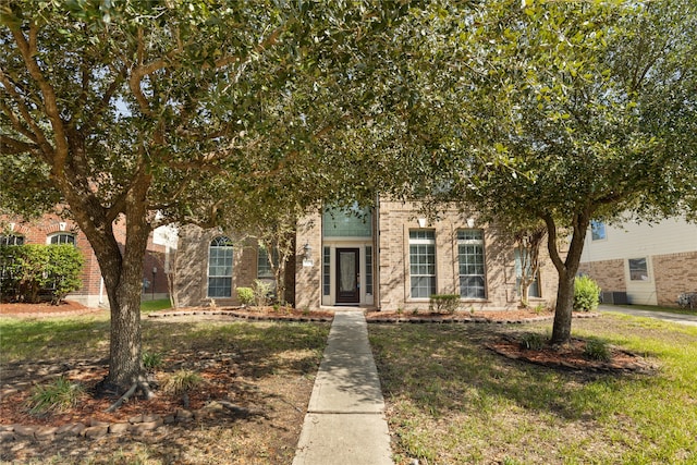 obstructed view of property featuring a front lawn