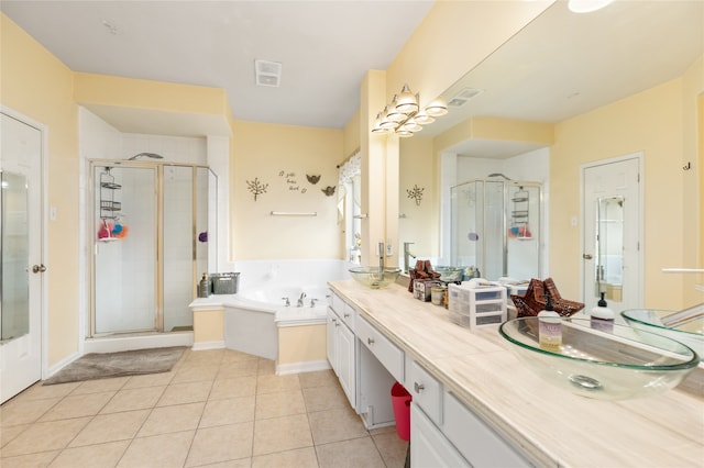 bathroom featuring tile patterned flooring, vanity, and separate shower and tub