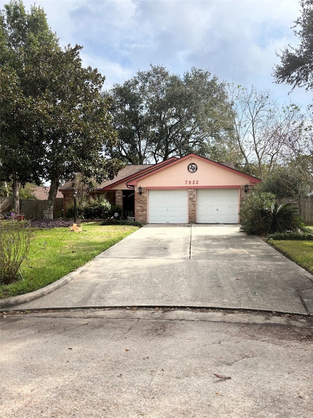 view of front facade featuring a garage and a front lawn