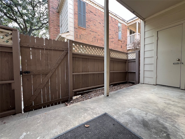 view of gate with a patio