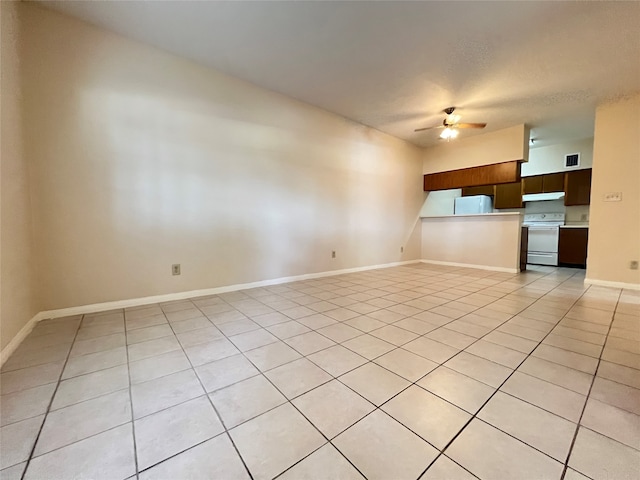 unfurnished living room featuring ceiling fan and light tile patterned flooring