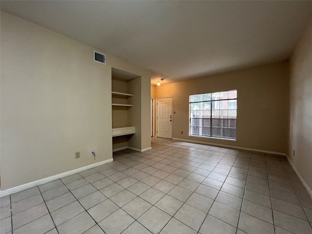 interior space with built in shelves and built in desk