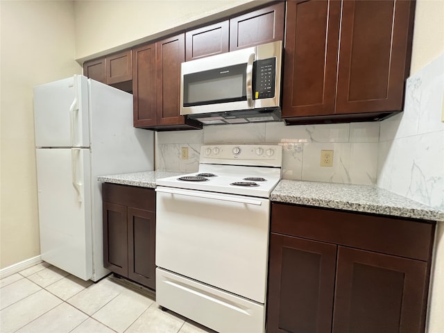 kitchen featuring white appliances, decorative backsplash, light stone counters, and light tile patterned flooring