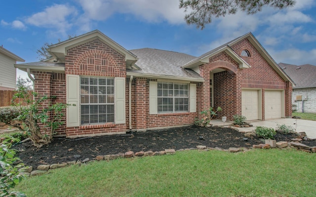 view of front facade with a garage and a front lawn