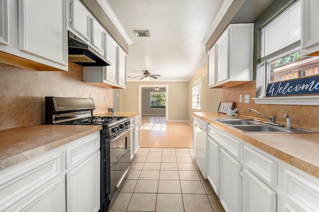 kitchen featuring gas stove, crown molding, white dishwasher, sink, and white cabinets