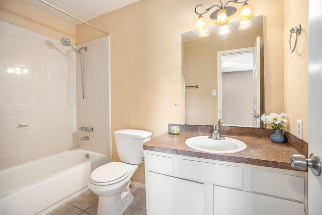 full bathroom with toilet, tiled shower / bath, tile patterned floors, and vanity