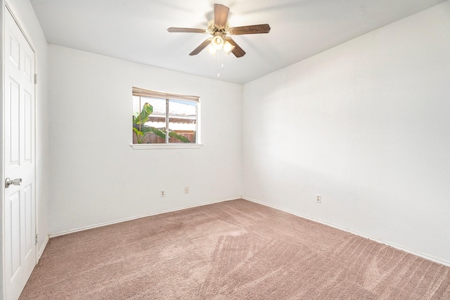 empty room with ceiling fan and carpet