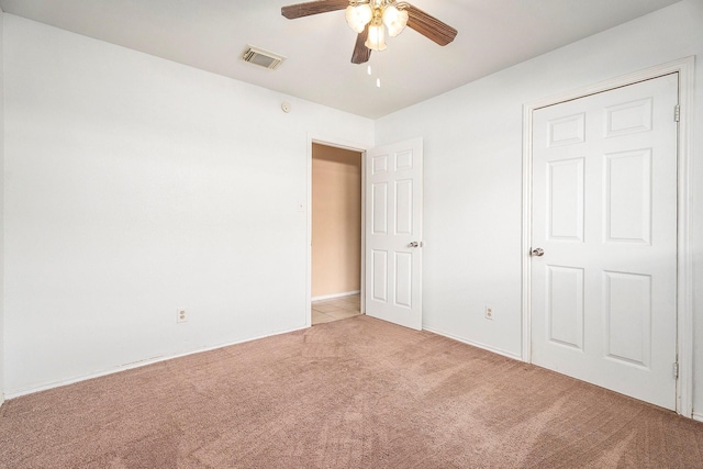 unfurnished bedroom featuring ceiling fan and light colored carpet