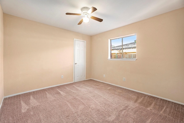 carpeted empty room with ceiling fan