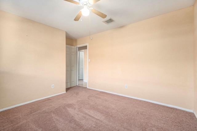 empty room with light colored carpet and ceiling fan