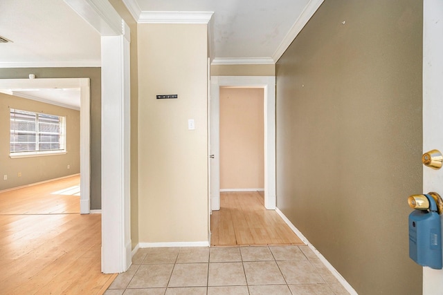 corridor featuring light hardwood / wood-style floors and crown molding