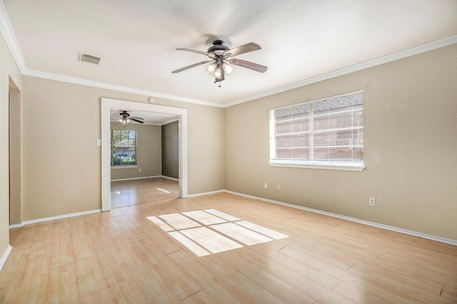 empty room with ceiling fan, crown molding, and light hardwood / wood-style flooring