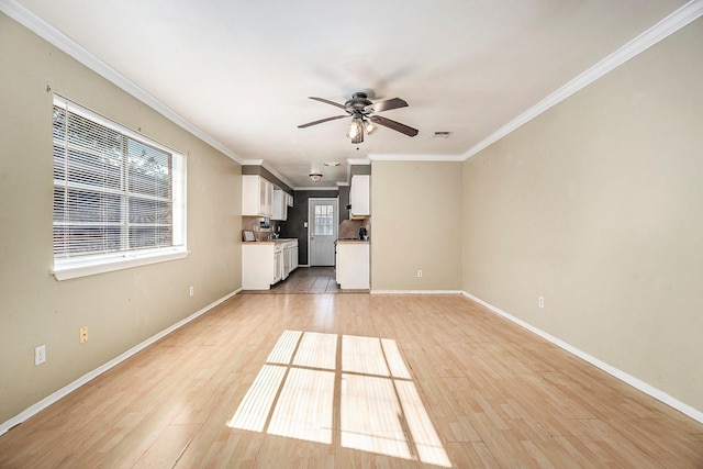 unfurnished living room featuring light hardwood / wood-style flooring, ceiling fan, and crown molding