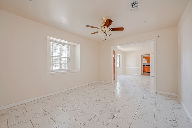 spare room featuring a wealth of natural light and ceiling fan