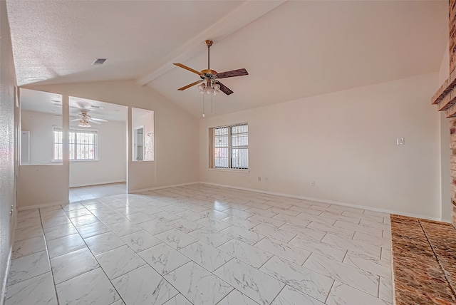 spare room featuring ceiling fan, plenty of natural light, and vaulted ceiling with beams