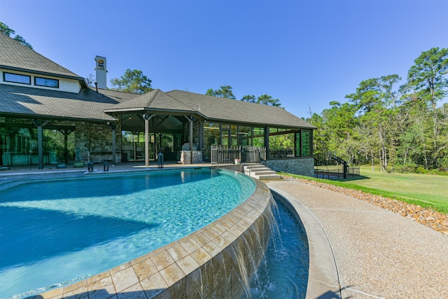 view of pool with pool water feature and a patio area