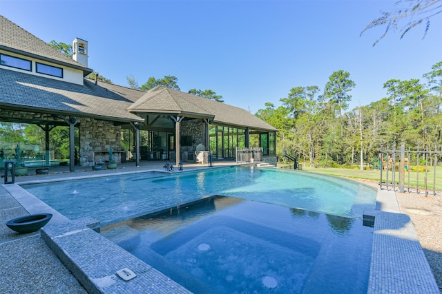 5015 Ossineke Ct, Spring, TX 77386 - view of swimming pool featuring a fireplace, a patio area, and a pool with connected hot tub