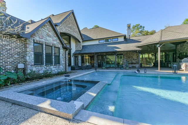 5015 Ossineke Ct, Spring, TX 77386 - outdoor pool with an in-ground hot tub, a patio area, and an outdoor living space with a fireplace