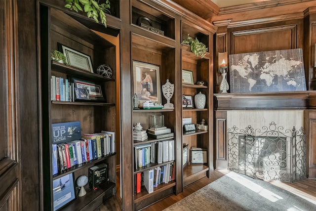 interior space with built in shelves and hardwood / wood-style floors