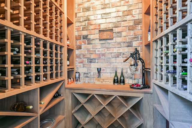 wine cellar featuring brick wall