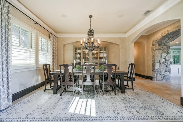 5015 Ossineke Ct, Spring, TX 77386 - dining area featuring a chandelier, arched walkways, ornamental molding, and baseboards