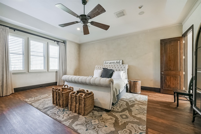 bedroom with crown molding, ceiling fan, and dark hardwood / wood-style floors