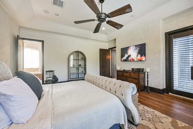 bedroom featuring dark wood-type flooring, multiple windows, and ceiling fan