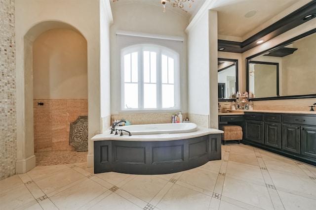 bathroom featuring tile walls, a washtub, and vanity