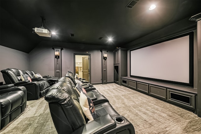 cinema room featuring vaulted ceiling and carpet floors