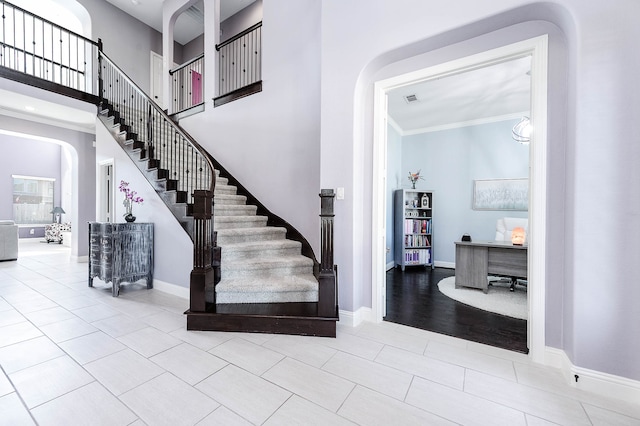 stairs featuring crown molding and hardwood / wood-style floors