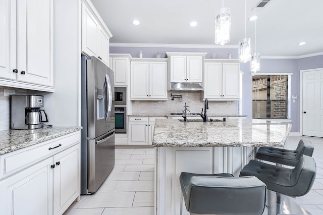 kitchen with a breakfast bar, stainless steel appliances, decorative light fixtures, and ornamental molding