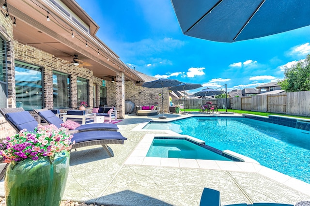 view of pool featuring a patio area, an in ground hot tub, ceiling fan, and an outdoor hangout area