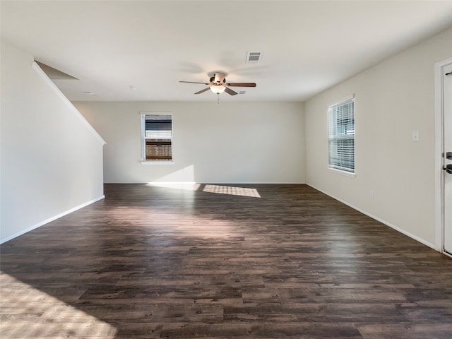 interior space featuring dark wood-type flooring and ceiling fan