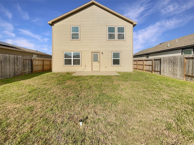 back of property featuring a lawn and a patio area