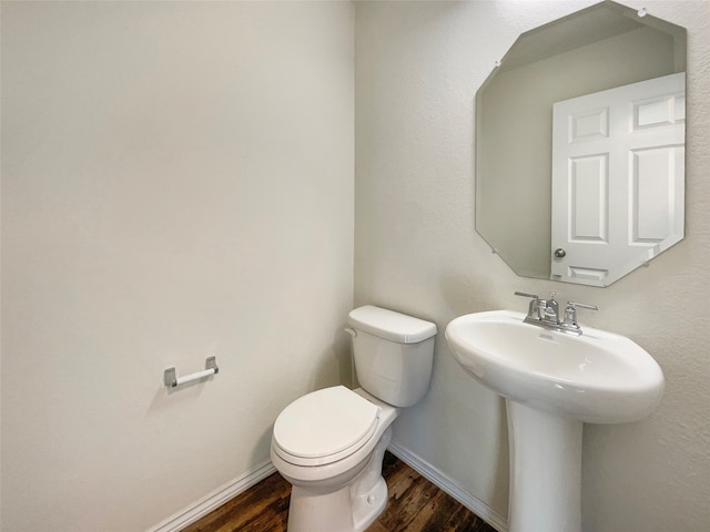 bathroom with toilet and hardwood / wood-style floors