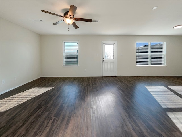 spare room featuring ceiling fan and dark hardwood / wood-style floors