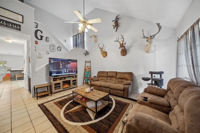 living room with light tile patterned floors, high vaulted ceiling, a wealth of natural light, and ceiling fan