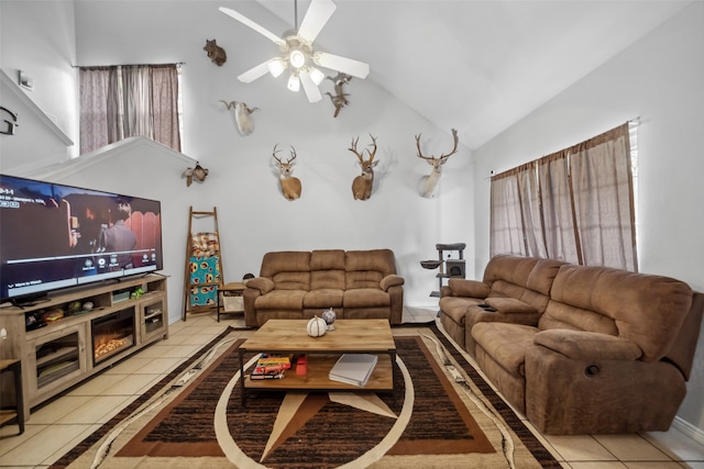 living room featuring ceiling fan, light tile patterned floors, and high vaulted ceiling