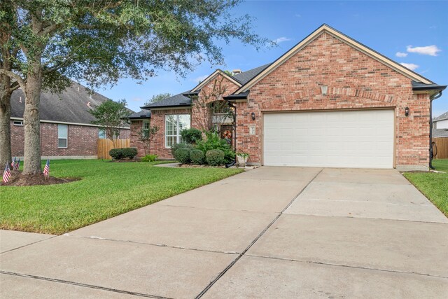 view of front property featuring a garage and a front lawn