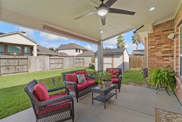 view of patio / terrace featuring outdoor lounge area, ceiling fan, and a storage shed